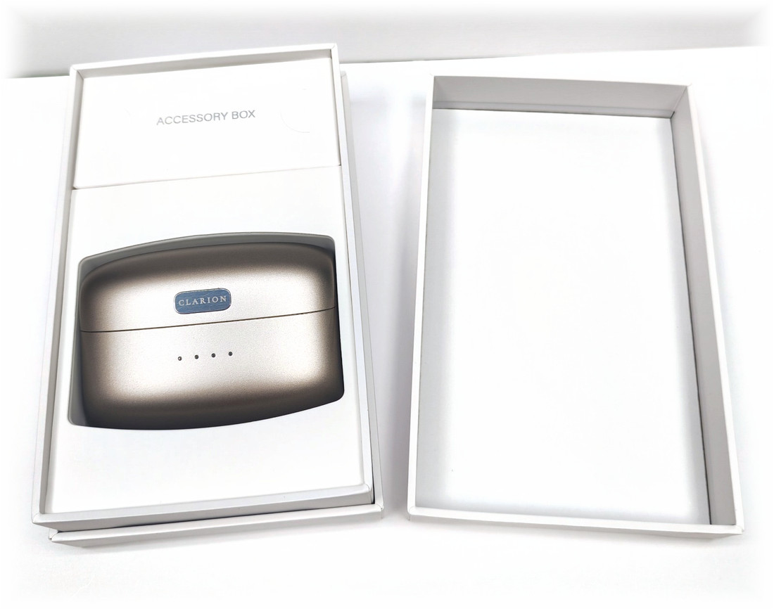 The presentation box open on white, the charging case seated inside it.