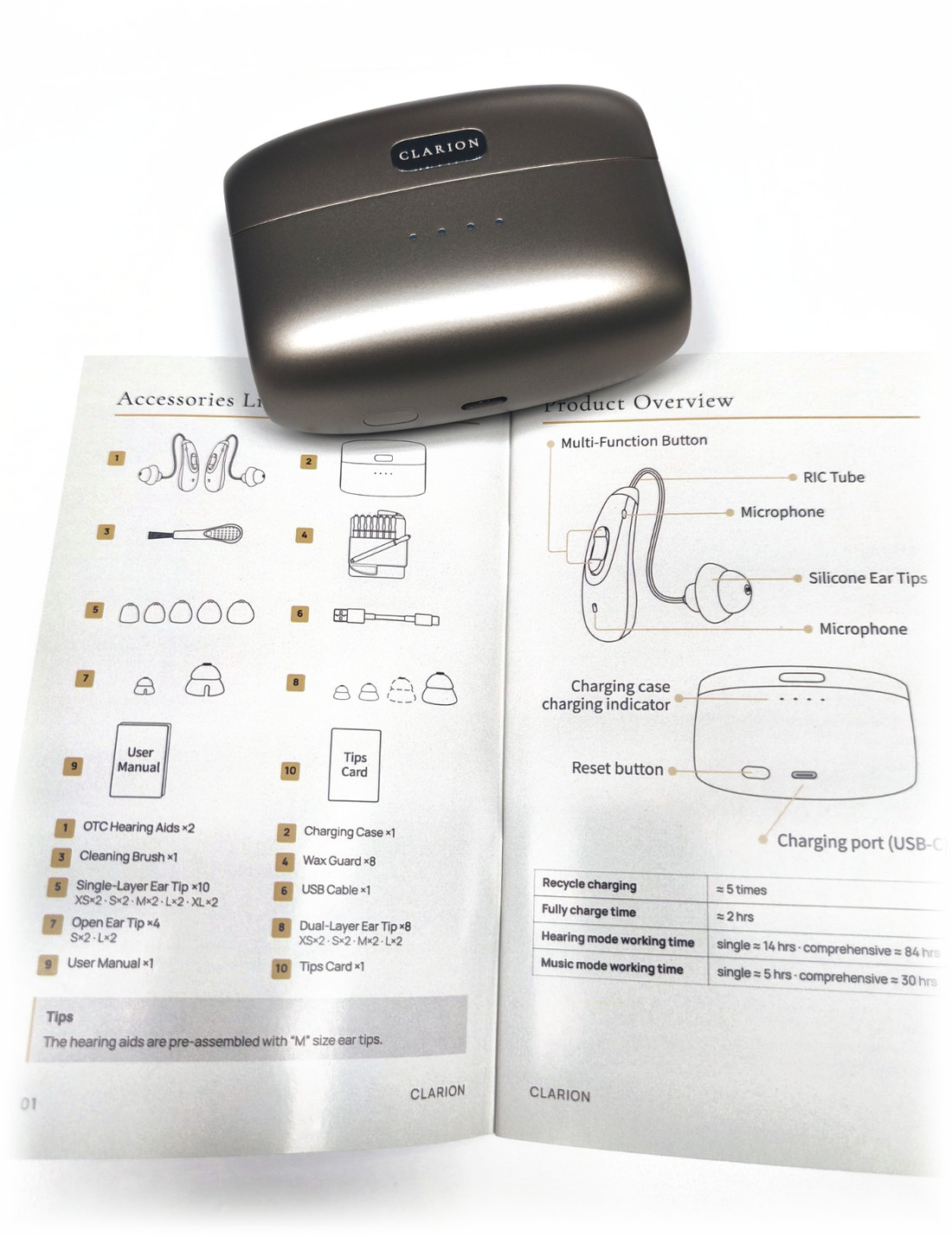 The charging case resting on the printed user manual, which lies open on white.